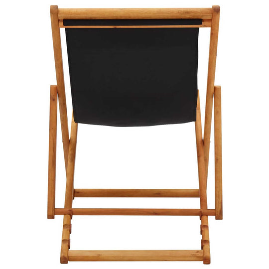 Folding beach chair with eucalyptus wood frame and black fabric, perfect for outdoor furniture and lounging.