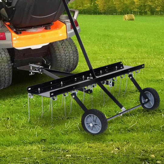 Scarifier attachment for ride-on mower on a green lawn, designed for easy moss removal and aeration.