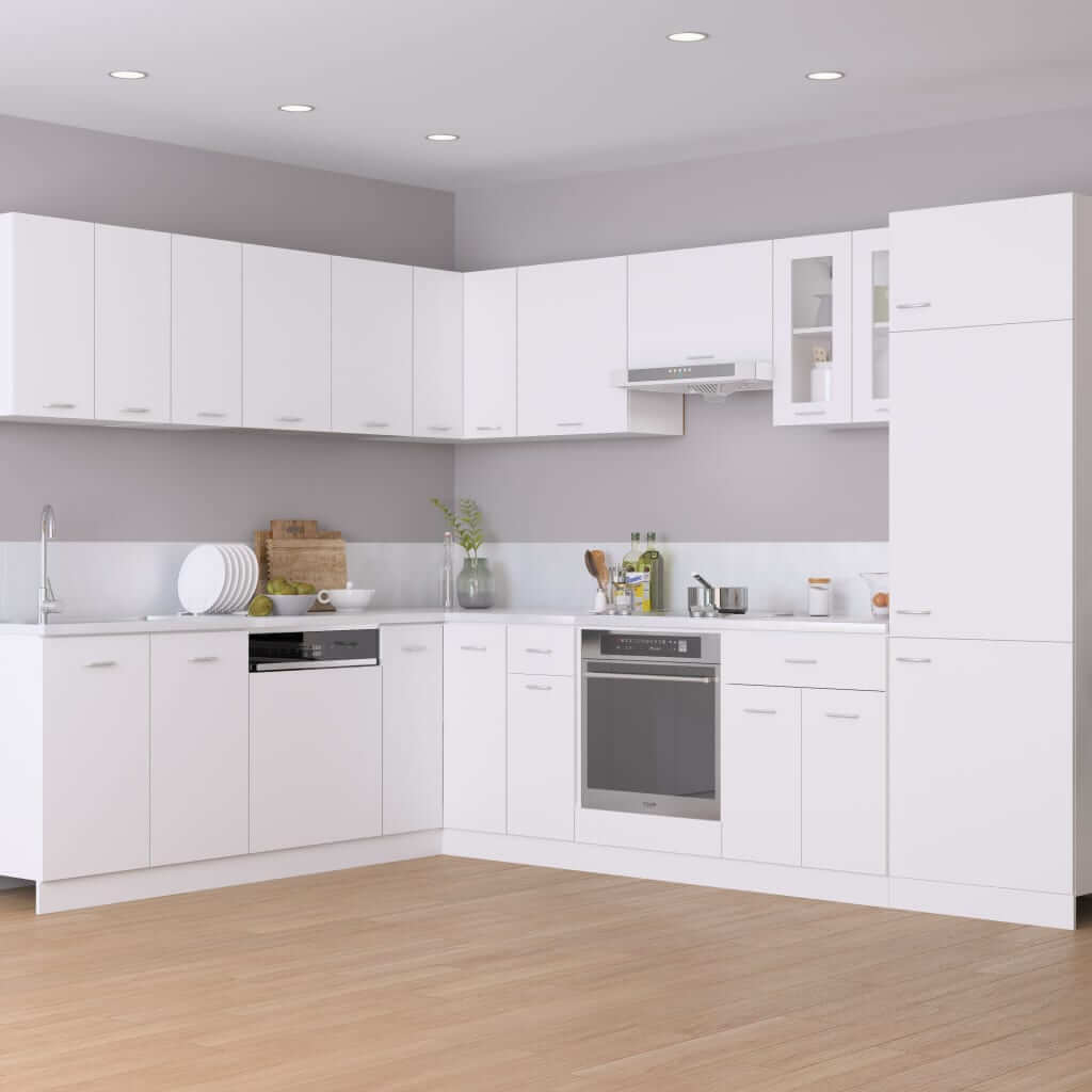 Modern white kitchen setup featuring cabinets and appliances, showcasing a sleek and organized design.