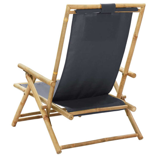 Dark grey bamboo folding relaxing chair with adjustable backrest and comfortable fabric seat, perfect for outdoor lounging.