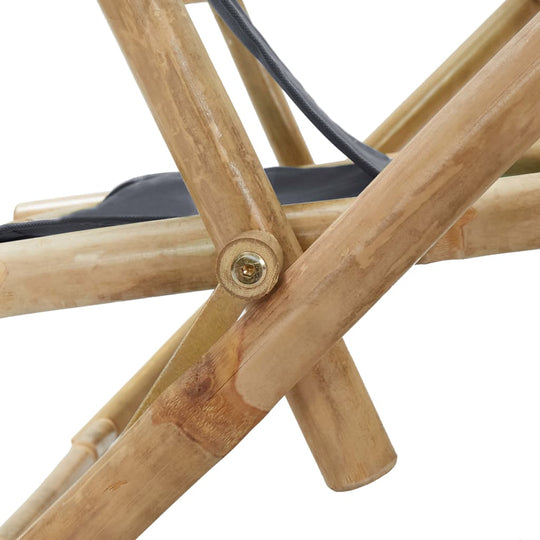 Close-up of the sturdy bamboo frame and adjustable mechanism of a dark grey reclining relaxing chair.