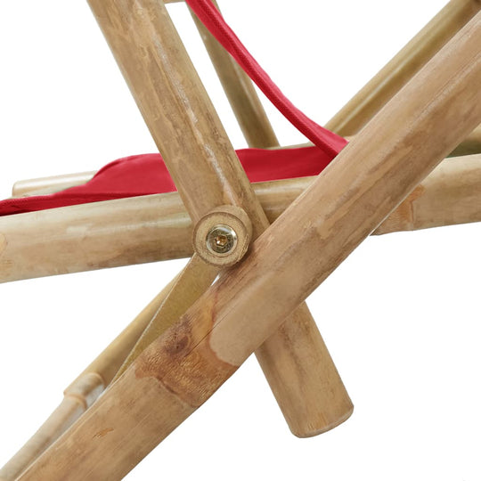 Close-up of the sturdy bamboo frame and red fabric of a reclining relaxing chair, showcasing its foldable design.