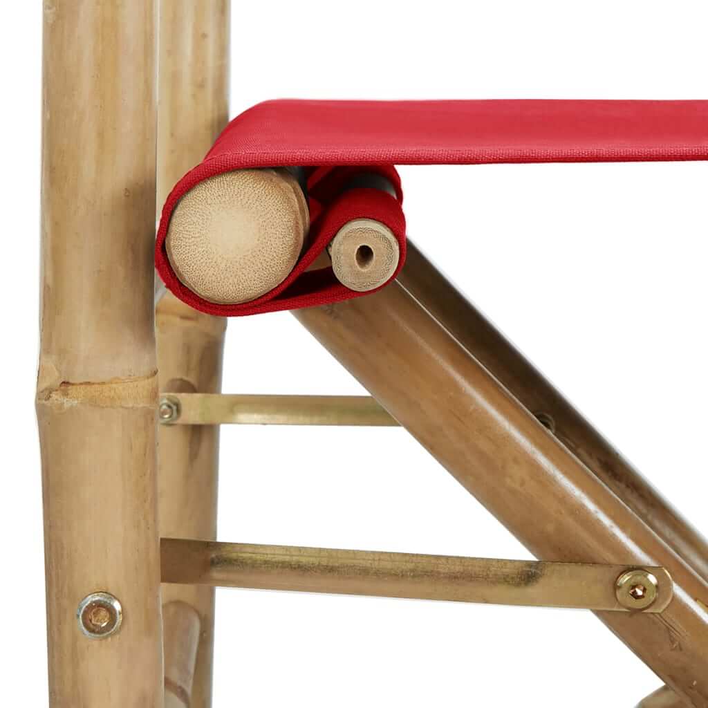 Close-up of red fabric rolled on bamboo support of a folding director's chair, showcasing its durable design for outdoor furniture.