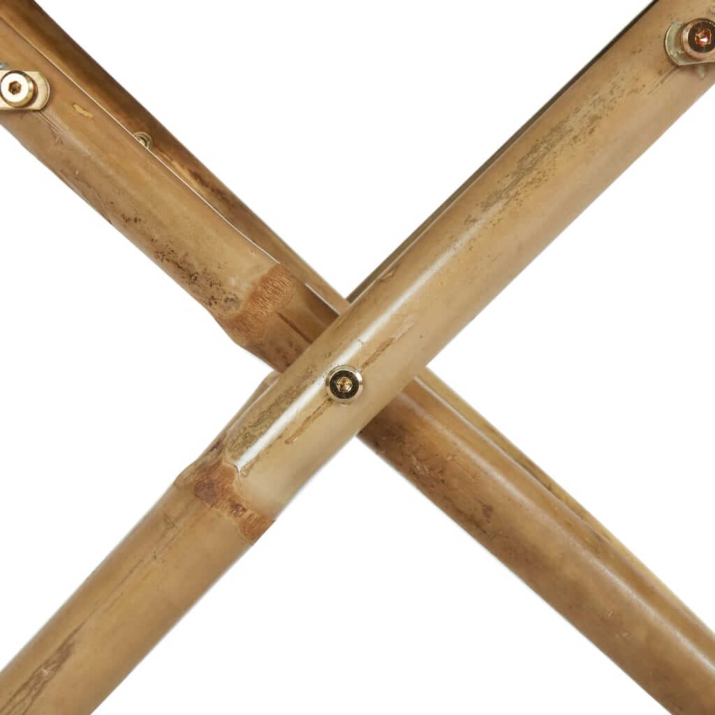 Close-up of bamboo frame of folding director's chair, showcasing sturdy cross-bracing for outdoor furniture stability.