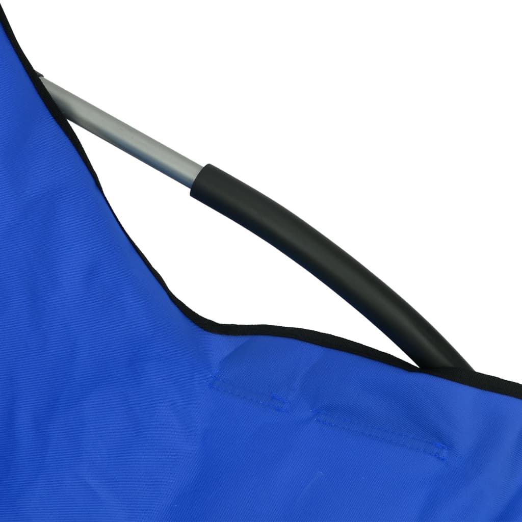 Close-up of blue fabric and steel frame of a folding beach chair, highlighting durability and comfort for outdoor relaxation.