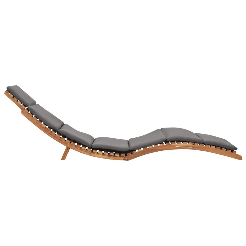 Folding sun lounger with dark cushion and solid teak wood, ergonomically curved for ultimate relaxation.