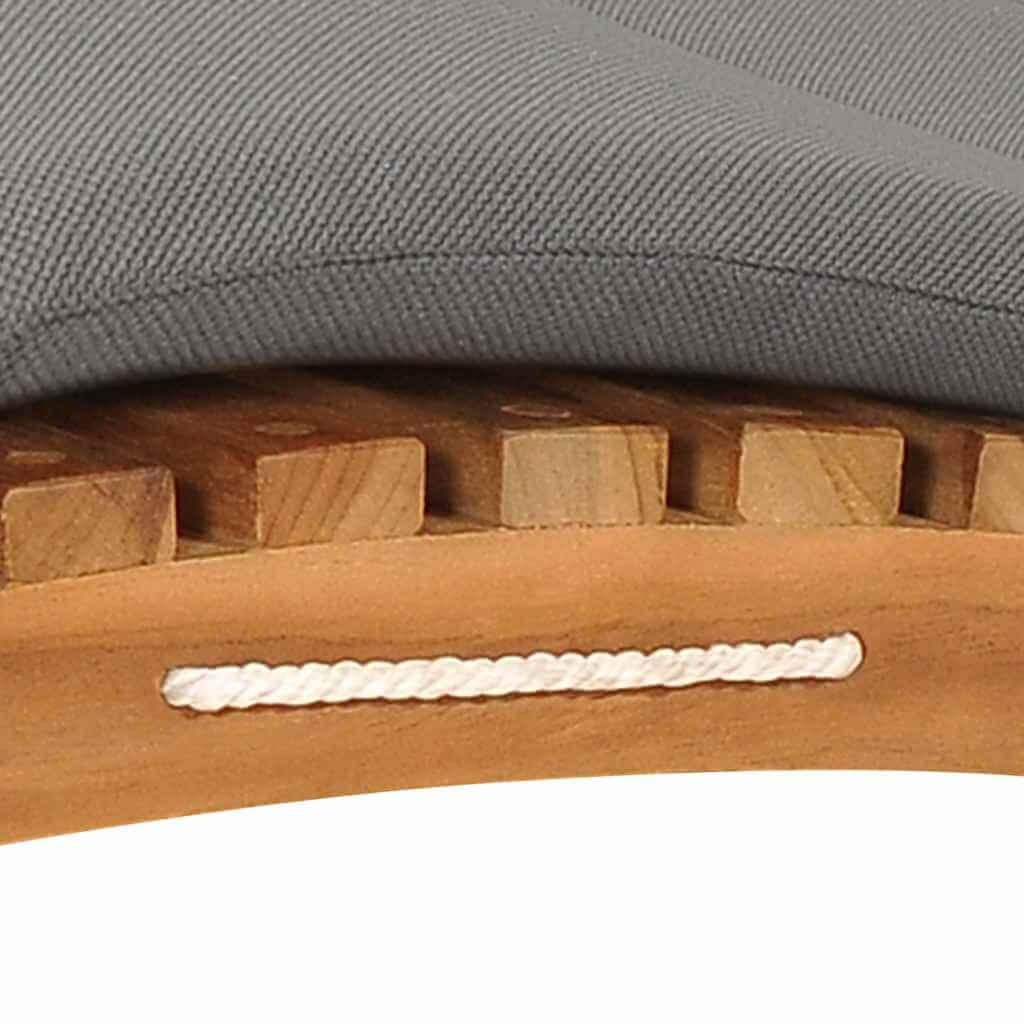 Close-up of a gray cushion on a teak wood sun lounger with a smooth finish and sturdy wooden slats.