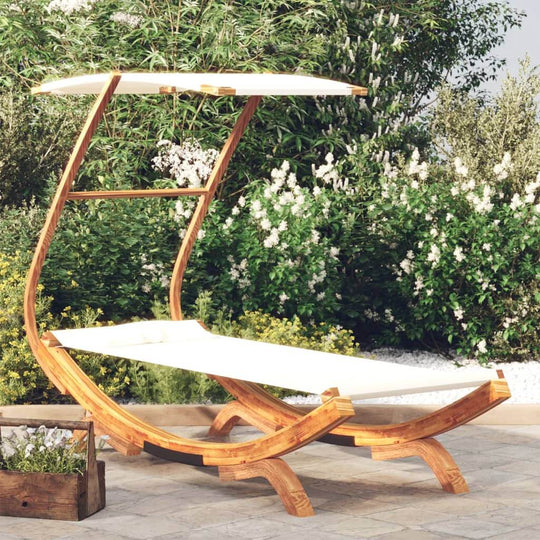 Outdoor lounge bed with canopy made of solid bent wood for garden relaxation, featuring cream fabric and a stylish design.