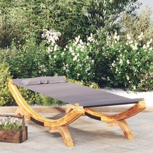 Outdoor lounge bed in solid bent wood with gray fabric, perfect for garden relaxation and durability in outdoor furniture.