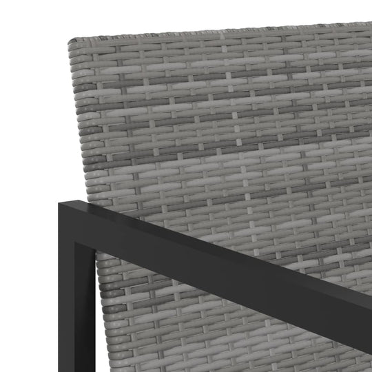 Close-up of grey poly rattan chair backrest and sturdy black powder-coated frame for outdoor dining set.