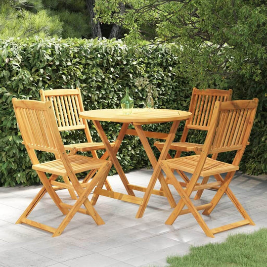 Folding garden dining set made of solid acacia wood, featuring a round table and four matching chairs in an outdoor setting.