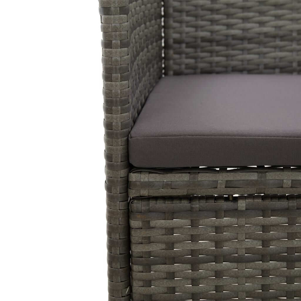 Close-up of grey poly rattan chair with cushion in a 3-piece garden dining set. Stylish and weather-resistant design.