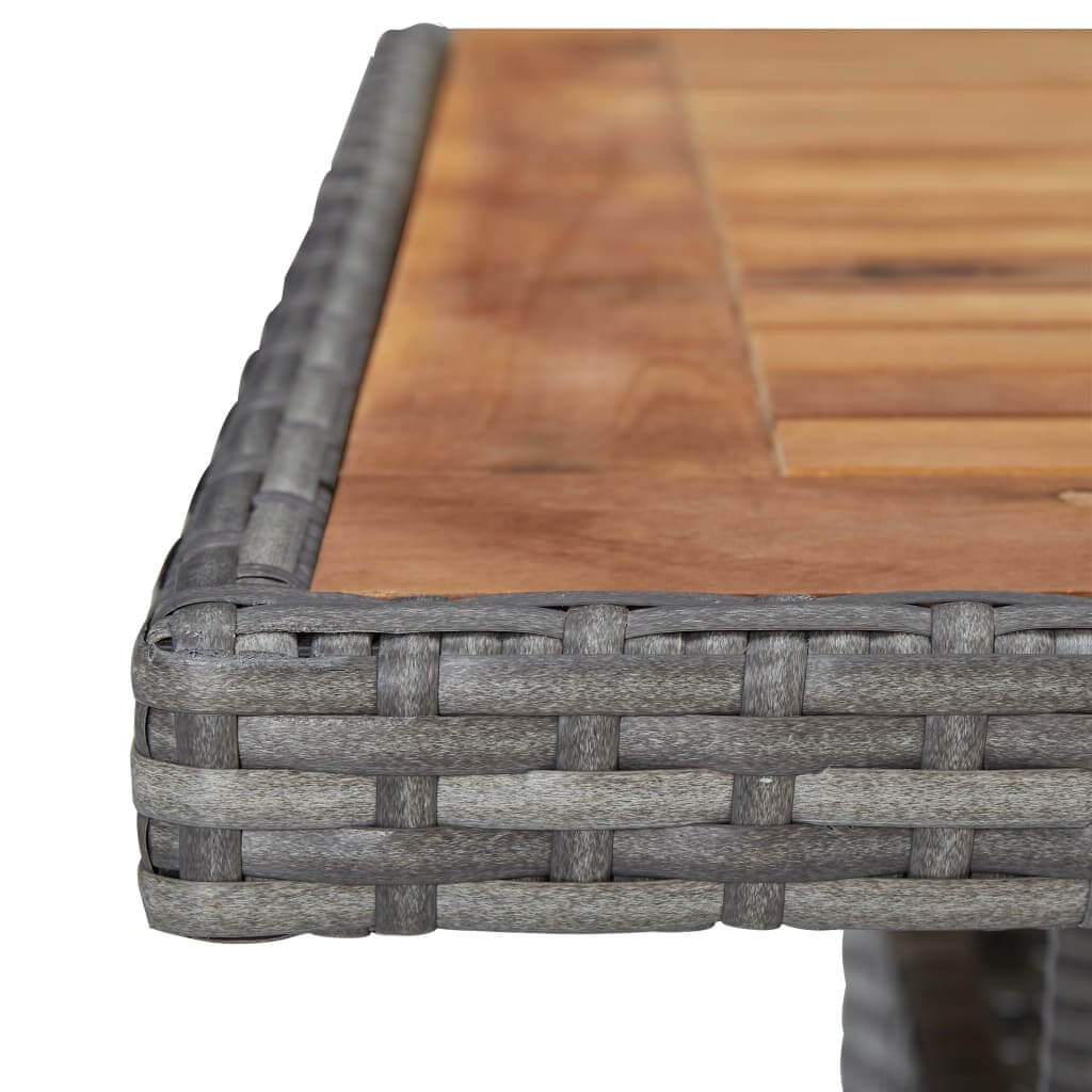 Close-up of the grey poly rattan edge and acacia wood tabletop of the garden dining set, showcasing quality craftsmanship.