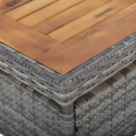 Close-up of the grey poly rattan and acacia wood tabletop of a garden dining set, showcasing its stylish design and durability.