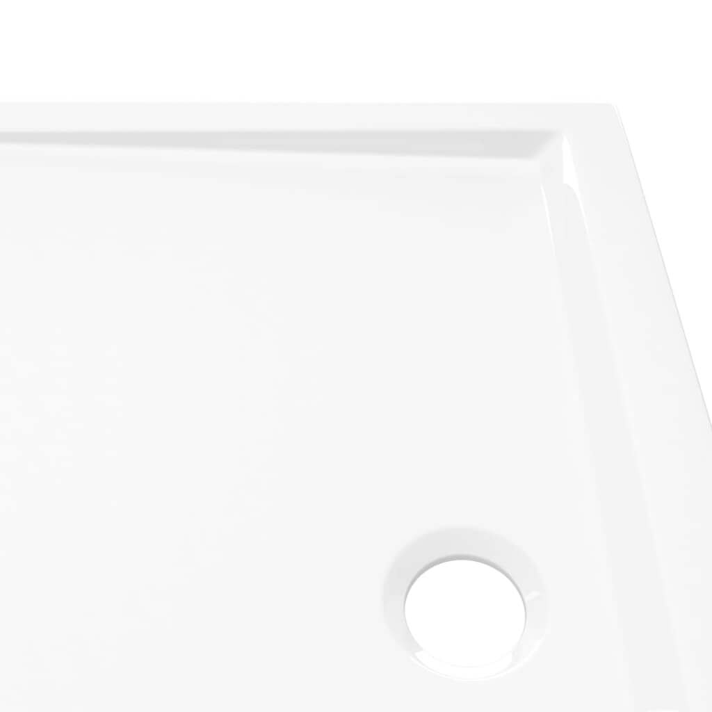 Close-up of a modern rectangular ABS shower base tray with a polished white finish and drainage hole. Perfect for stylish bathrooms.