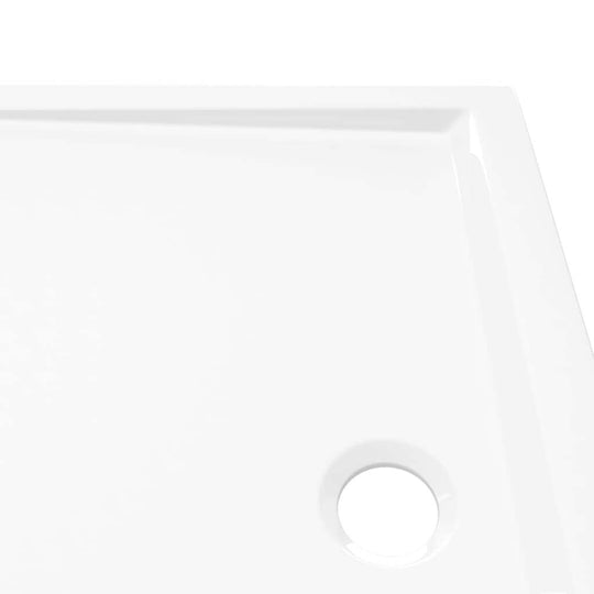 Close-up of a modern rectangular ABS shower base tray with a polished white finish and drainage hole. Perfect for stylish bathrooms.