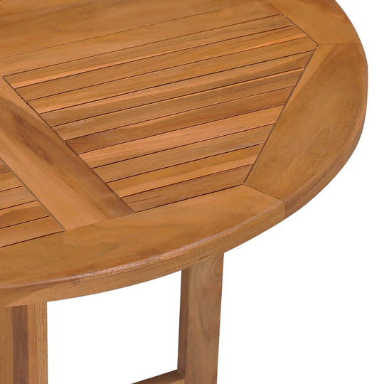 Close-up of a folding garden dining table made from solid teak wood, showcasing its smooth, slatted surface and durable finish.