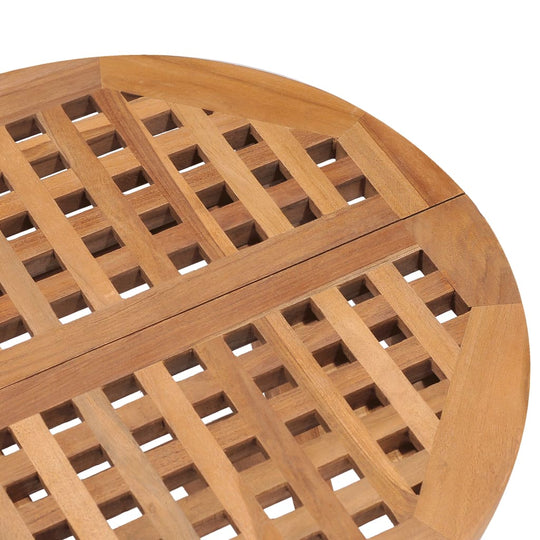 Close-up view of the intricate lattice design on a round teak wooden garden table, showcasing its smooth finish and durability.