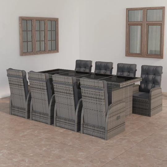 9 piece outdoor dining set in grey with cushions, featuring a glass tabletop and durable poly rattan construction.