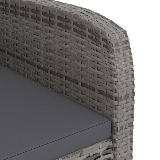 Close-up of the grey poly rattan weave on an outdoor dining set armrest with a cushioned seat.