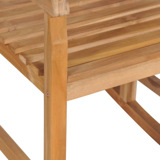 Close-up of solid teak wood slats on a rocking chair, showcasing its smooth finish and durable construction.