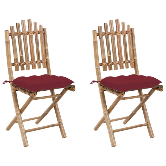Set of 2 folding bamboo garden chairs with red cushions, perfect for outdoor dining and lounging.