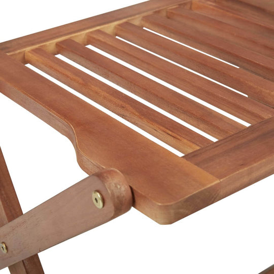 Close-up of solid acacia wood folding garden chair slats highlighting durable construction and natural finish.