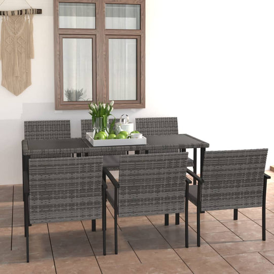 7 piece grey poly rattan garden dining set with a steel frame, suitable for outdoor use, displayed on a patio.