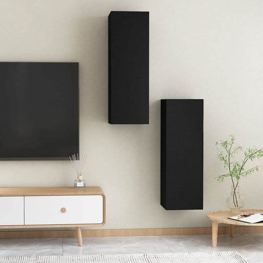 Black wall-mounted TV cabinets in a modern living room setup with engineered wood furniture and a minimalist design.