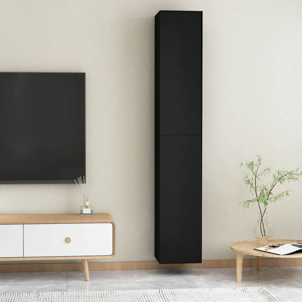 Black wall-mounted TV cabinet set in modern living room with minimalistic decor and stylish furnishings.