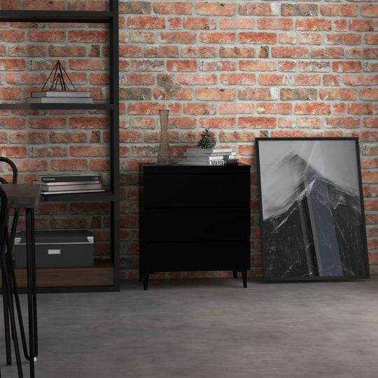 Black sideboard with three drawers beside a bookshelf and artwork on a brick wall background, ideal for industrial-style decor.