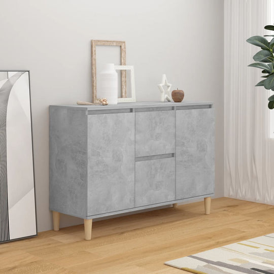 Elegant concrete grey sideboard cabinet with wooden legs, featuring two doors and two drawers for ample storage in a modern living space.