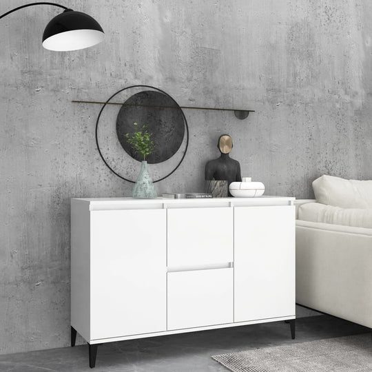 White sideboard with metal legs and ample storage, styled with decor in a modern living room setting.