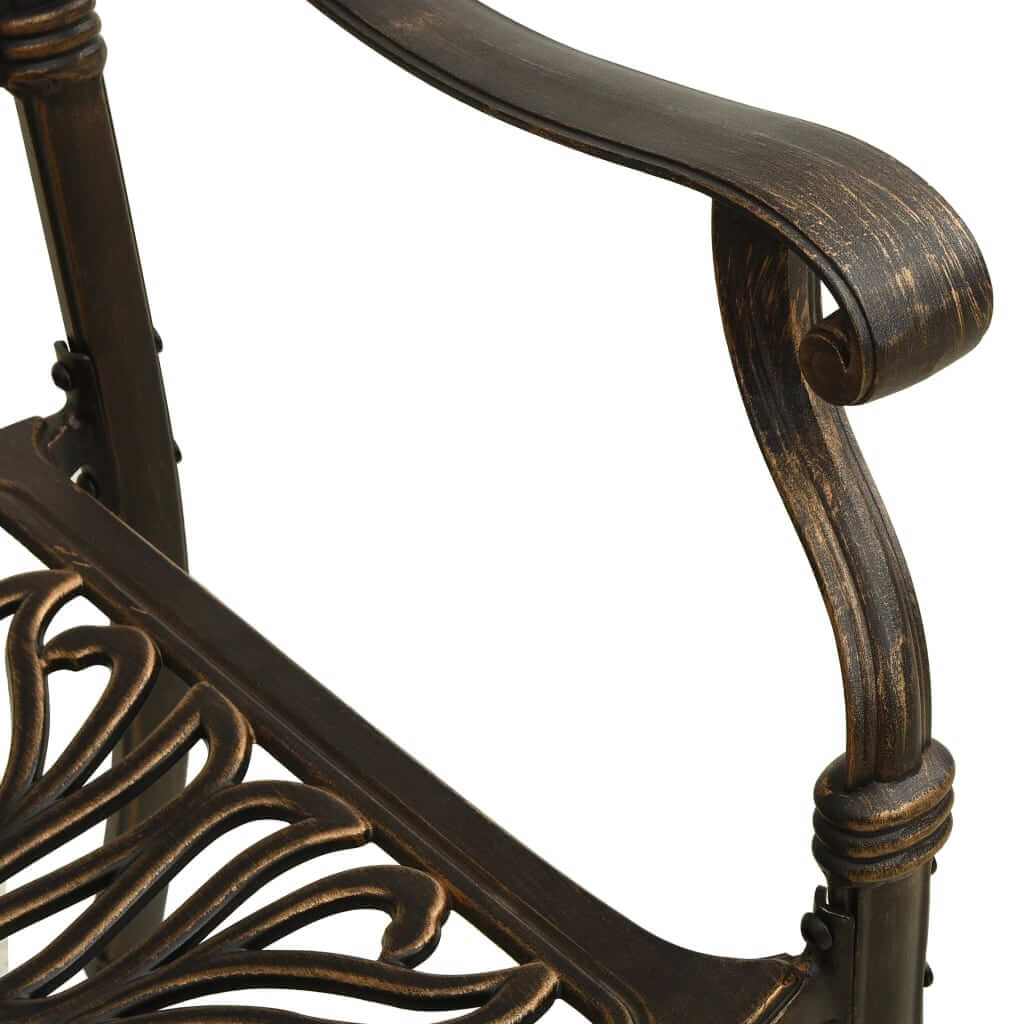 Close-up of cast aluminium bistro chair with intricate design and bronze finish, highlighting comfort and durability.