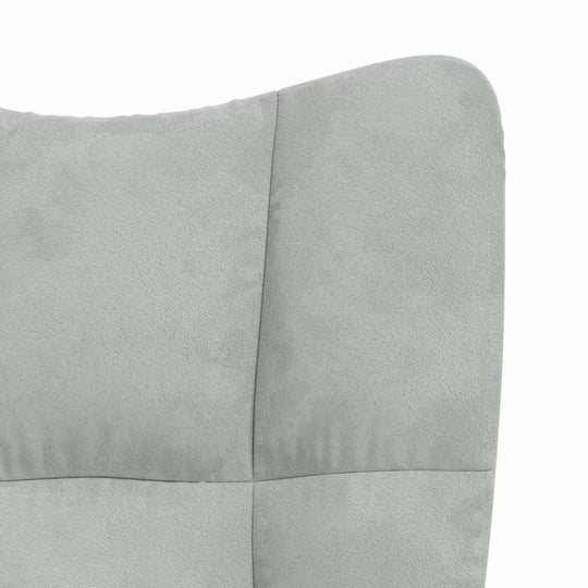 Light grey velvet upholstery of a modern rocking chair, showcasing its chic design and comfortable padding.