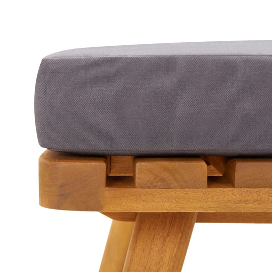 Close-up of gray cushion on solid acacia wood frame of outdoor lounge furniture. Perfect for garden relaxation.