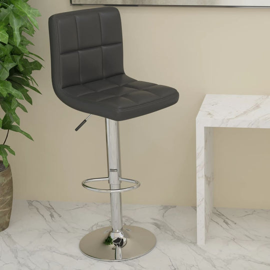 Black faux leather bar stool with chrome base, perfect for outdoor and patio furniture settings.