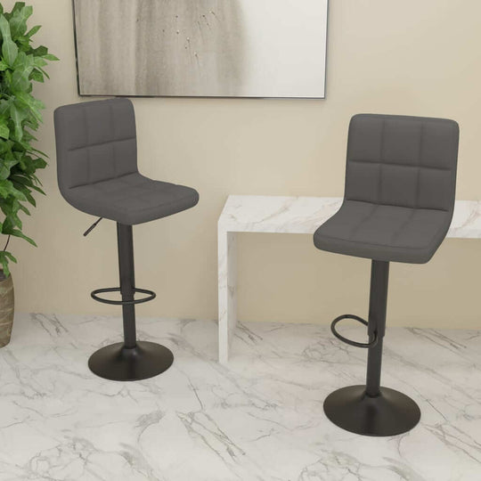 Dark grey fabric bar stools with chrome-finished base in modern home setting, perfect for outdoor and patio use.