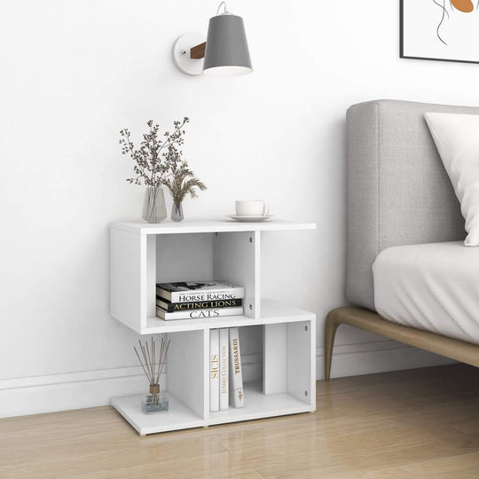 Modern white bedside cabinet with open compartments, perfect for storage and display in a cozy bedroom.