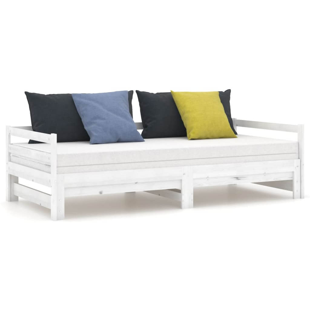 Pull-out day bed in solid pinewood with colorful cushions, versatile for use as a sofa or bed, ideal for small spaces