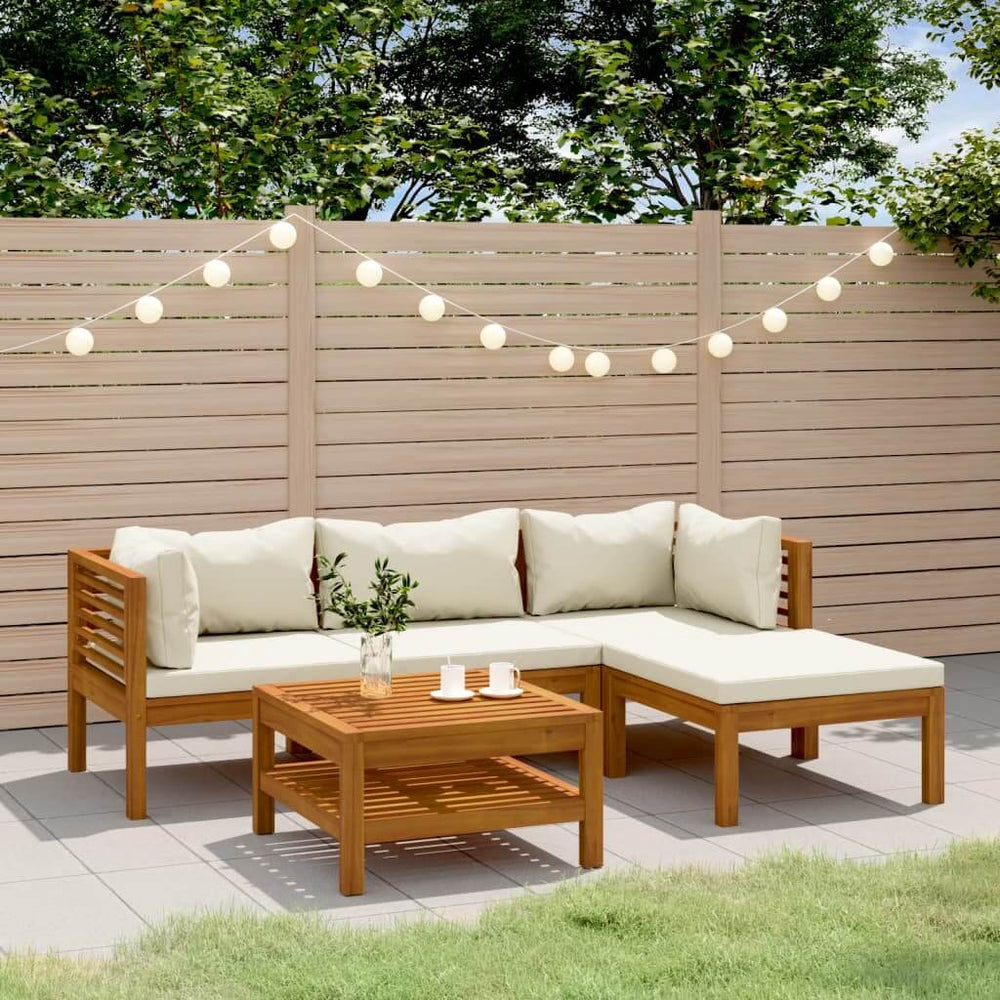Outdoor garden lounge set with cushions in solid acacia wood featuring a modular design and modern coffee table on patio.