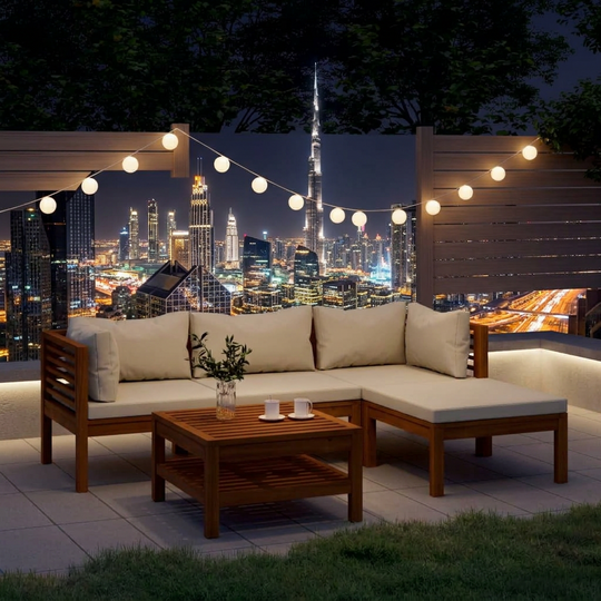 Outdoor garden lounge set with cushions in solid acacia wood featuring a modular design and modern coffee table on patio.