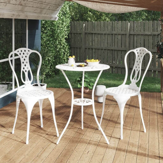 White cast aluminium 3 piece bistro set with decorative chairs, perfect for outdoor dining in a garden or patio setting.