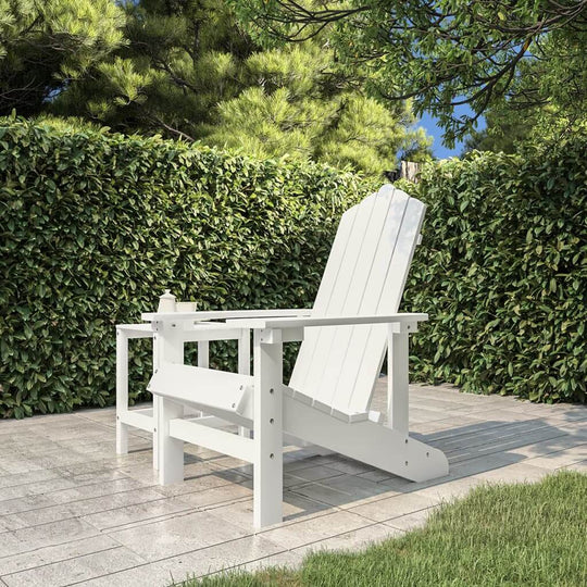 White HDPE garden Adirondack chair on patio, surrounded by greenery, perfect for outdoor furniture relaxation.