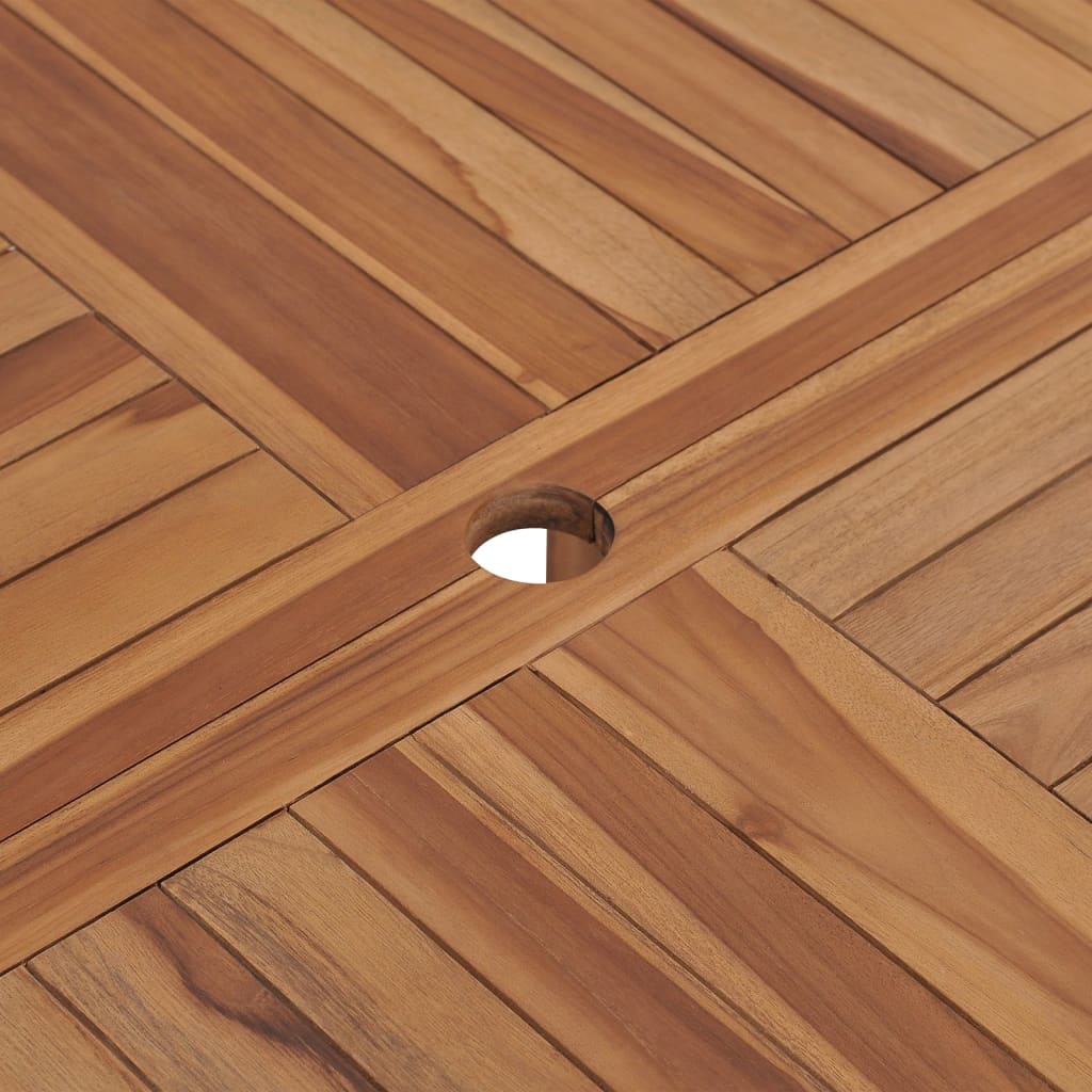 Close-up of a solid teak garden dining table surface featuring a smooth finish and an umbrella hole.