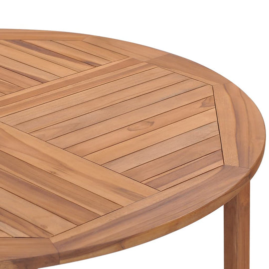 Close-up of a teak wood garden dining table with a smooth, natural finish and stylish slatted design.