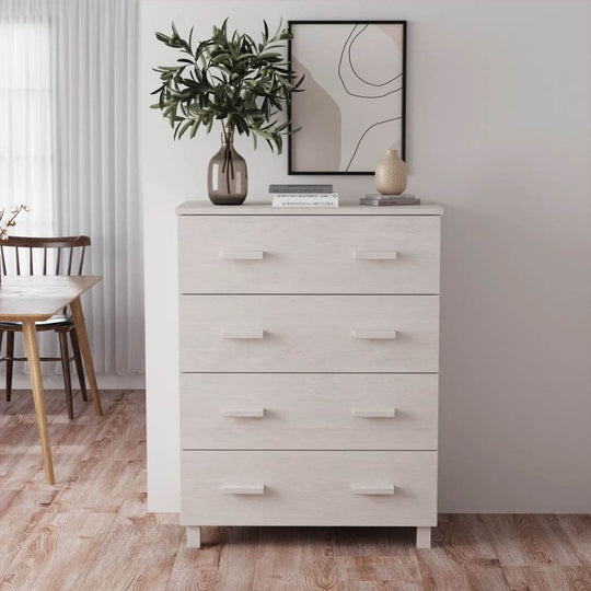 Modern white sideboard with four drawers and decor, placed in a bright room with plants and art on the wall.