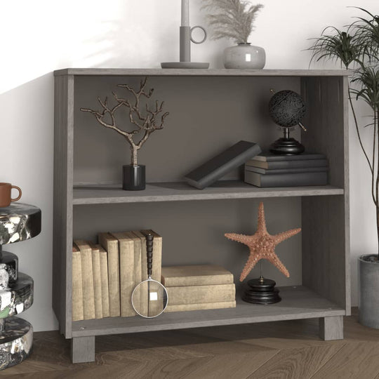 Sideboard in light grey solid pine wood with decor items on shelves, including books, a starfish, and a decorative globe.