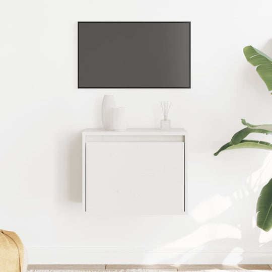 Wall cabinet in white solid pinewood displayed above a minimalist setup with a TV, plant, and decorative items.