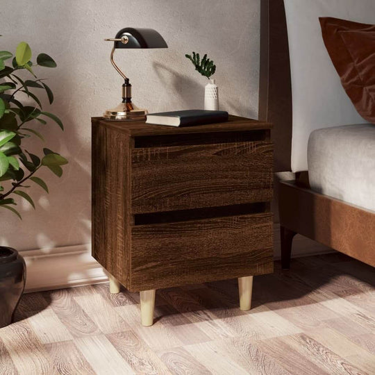 Chic brown oak bed cabinet with solid wood legs, two drawers, and a stylish lamp, enhancing Scandinavian interior design.